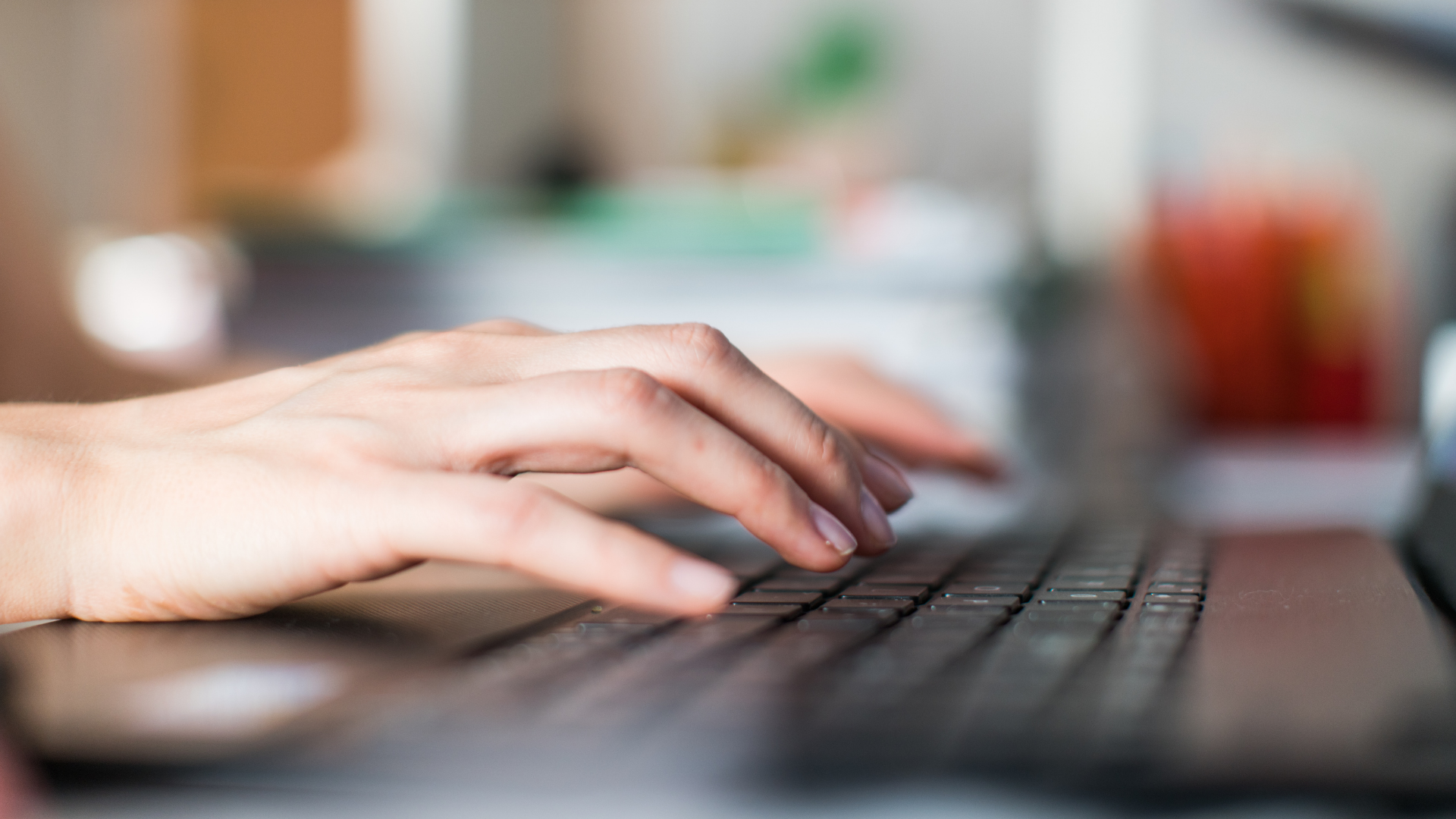 hand typing on computer keyboard